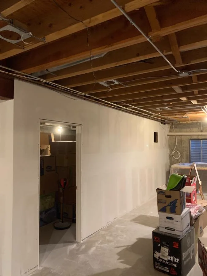 Basement drywall hung and taped in progress