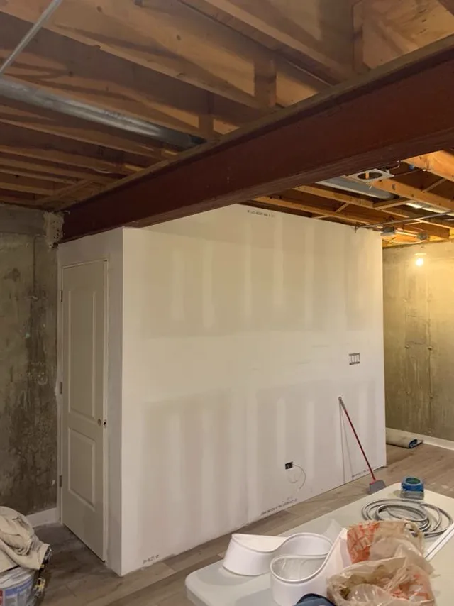 Drywall board freshly hung on basement walls